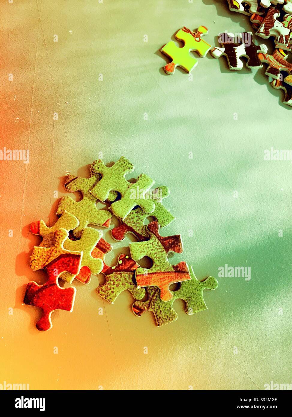 Jigsaw puzzle pieces in separate stacks during the process of assembly - Smartphone Captured Stock Image