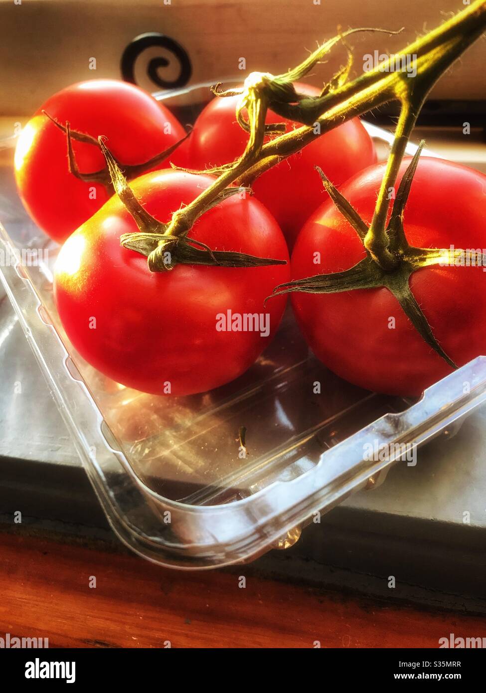 Tomatoes in a plastic tray - Smartphone Captured Stock Image