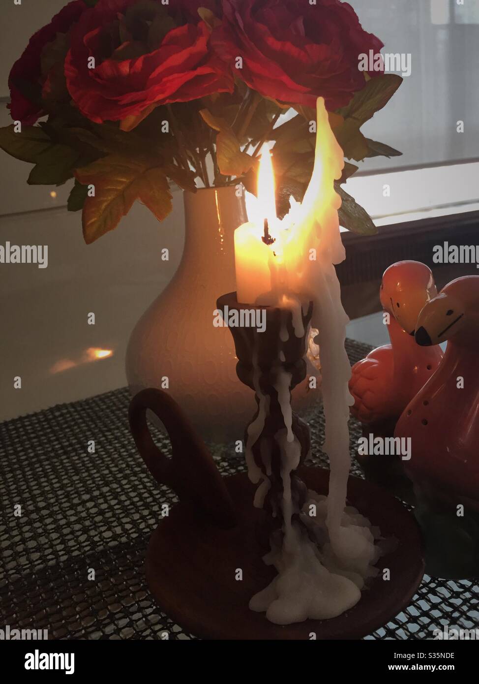 Candle wax drips from a hand carved  wooden candle stick - Smartphone Captured Stock Image