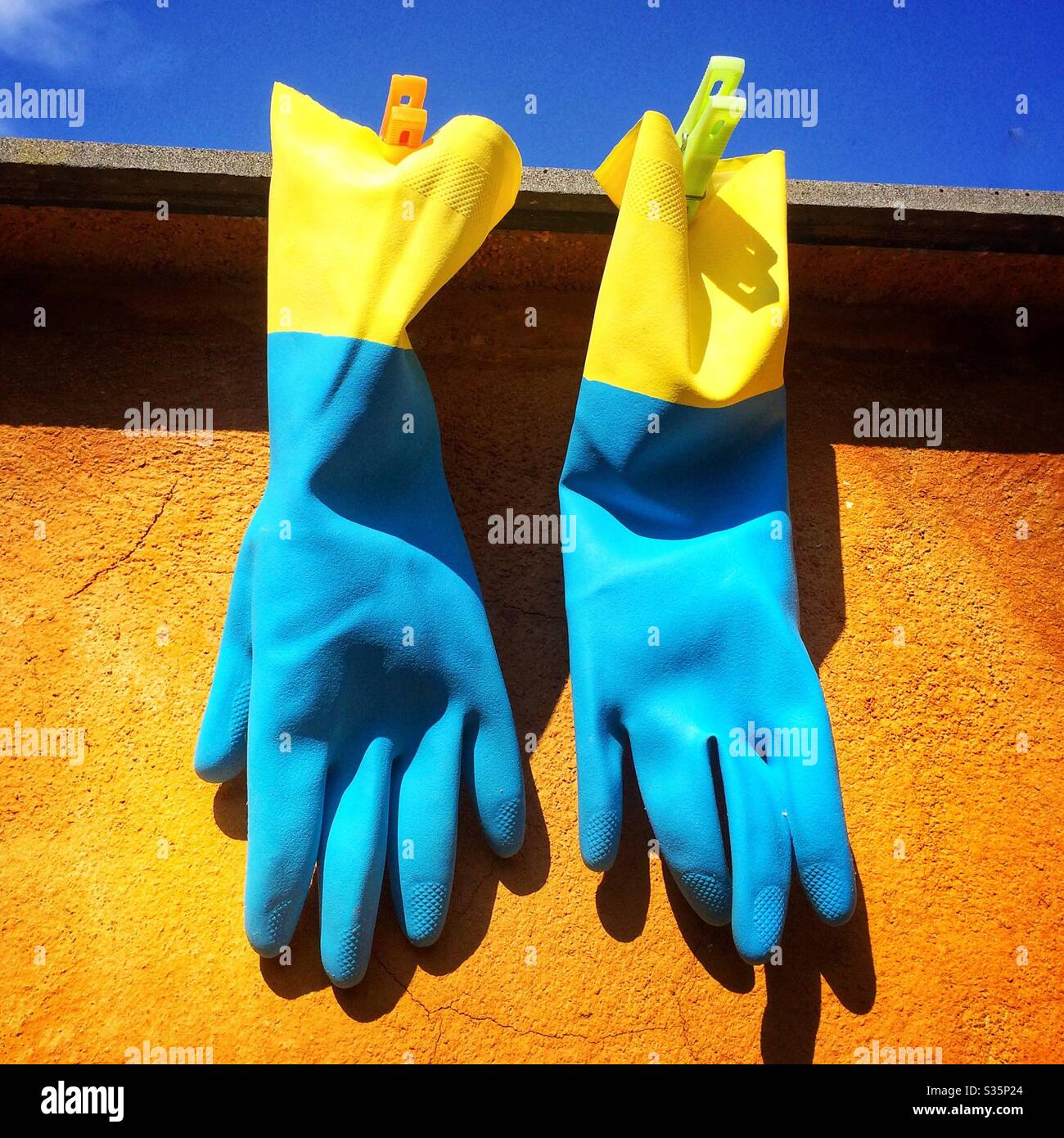 Protective gloves hanging for protection from virus covid-19 coronavirus - Smartphone Captured Stock Image