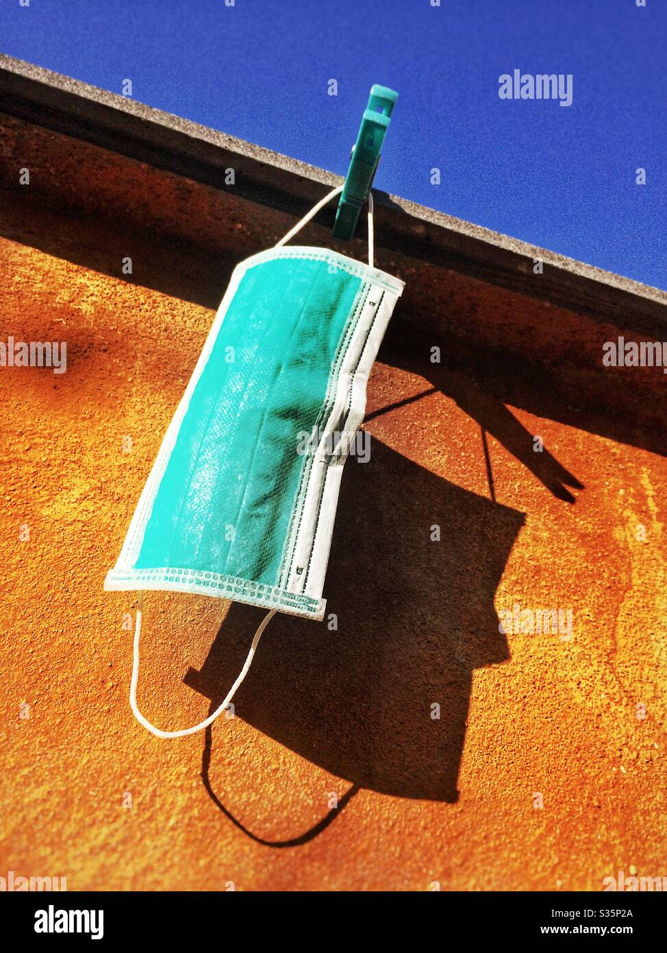 Medical mask hanging for protection from covid-19 coronavirus - Smartphone Captured Stock Image