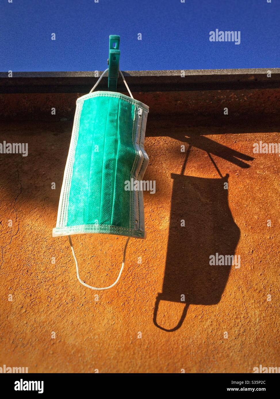 Medical mask hanging for protection from virus covid-19 coronavirus - Smartphone Captured Stock Image