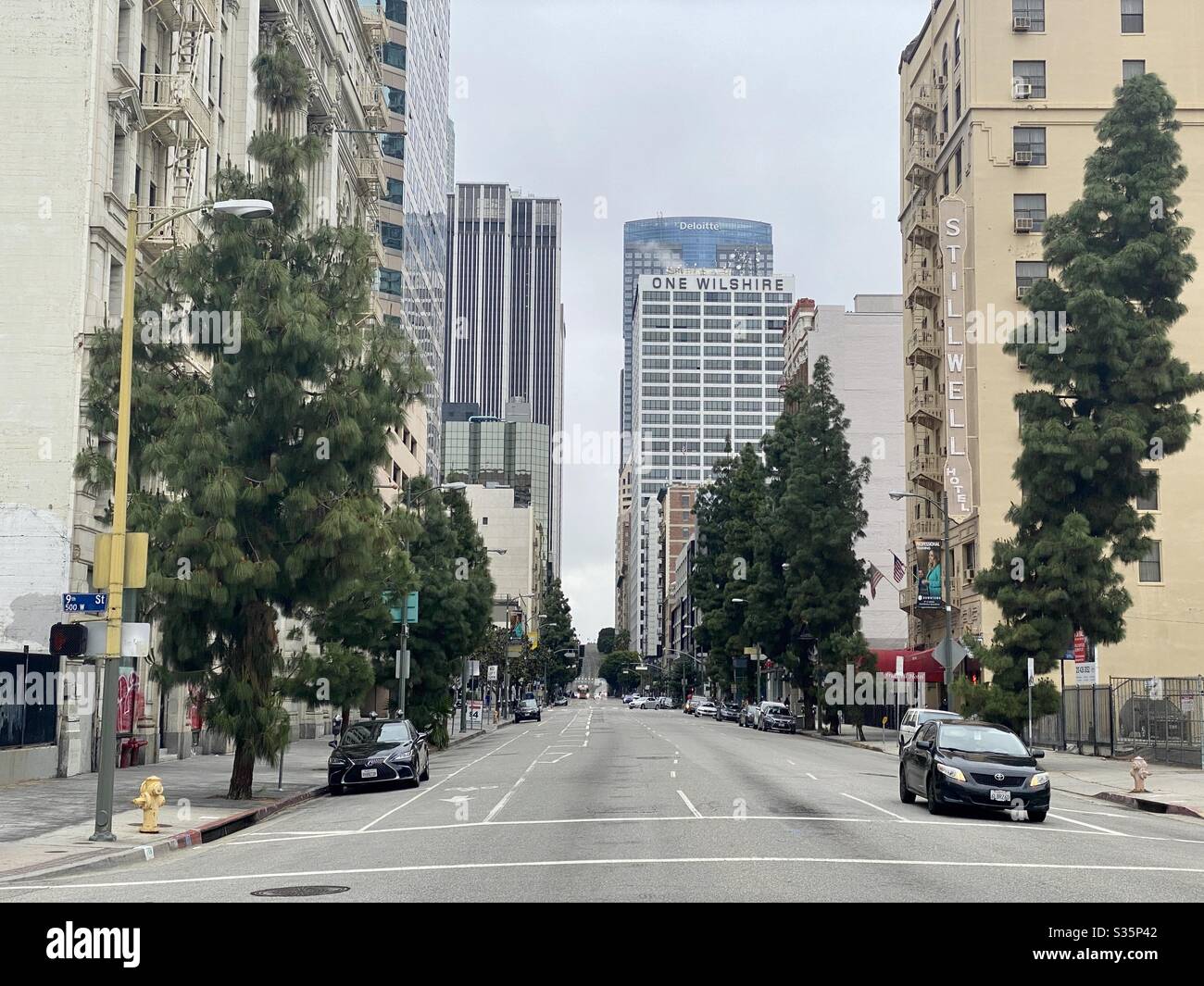 LOS ANGELES, CA, APR 2020: light traffic near the financial district, Downtown. Apartment buildings nearby, Stillwell Hotel and One Wilshire on the right - Smartphone Captured Stock Image