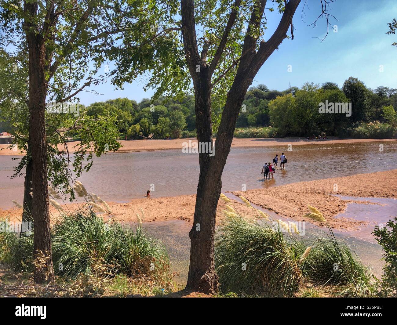 People walking through a riverbed in Northern Argentina. - Smartphone Captured Stock Image