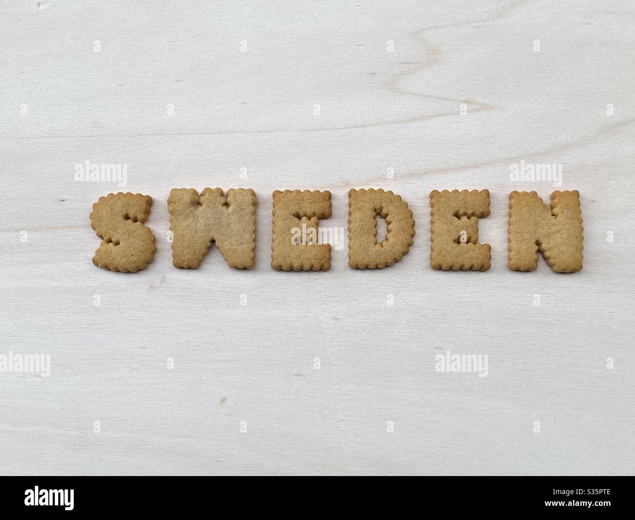 Sweden, nordic european country composed with cookie letters on a white wooden board Stock Photo