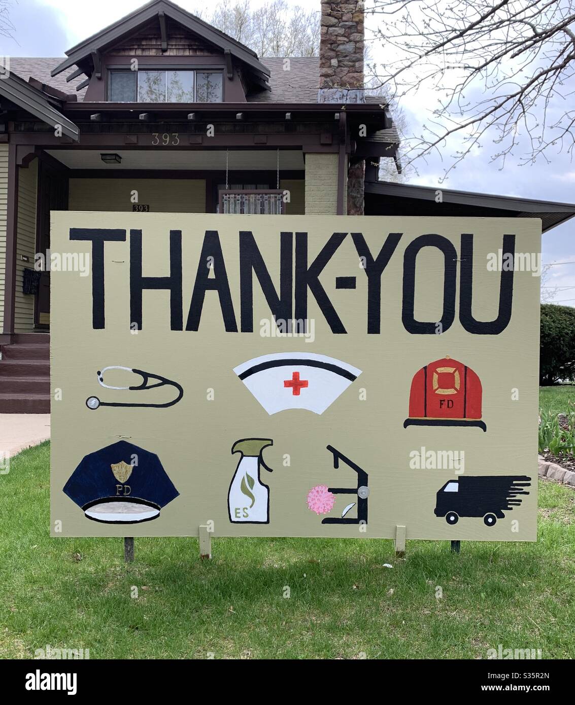 DUBUQUE, IOWA, April 27, 2020–Landscape photo of thank you signage in residential yard thanking frontline workers in Iowa during the Covid-19 Pandemic on sunny spring day. Stock Photo