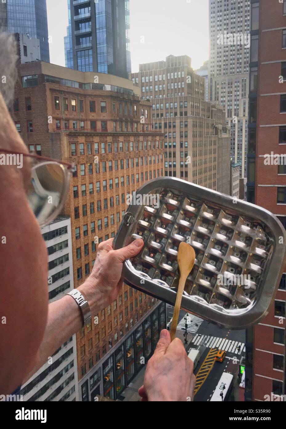 Every night at 7 o’clock in the in the city New York salute  the frontline healthcare workers by Banging on pots and pans, NYC, USA, 2020 - Smartphone Captured Stock Image