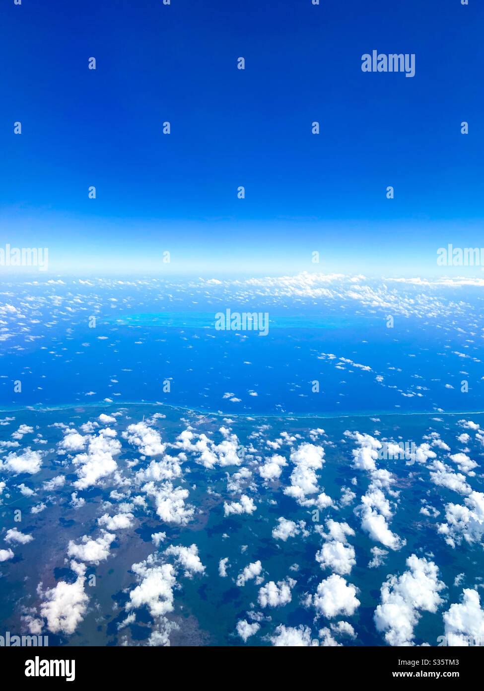 View from an airplane over the Caribbean Sea between Belize City and Miami, Florida on March 14, 2020. Stock Photo