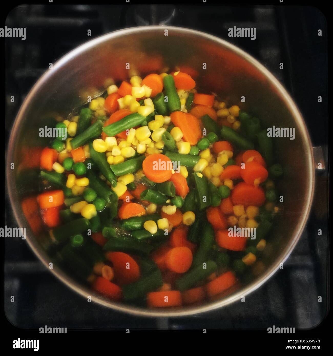 Pot of mixed vegetables on gas stove top - Smartphone Captured Stock Image