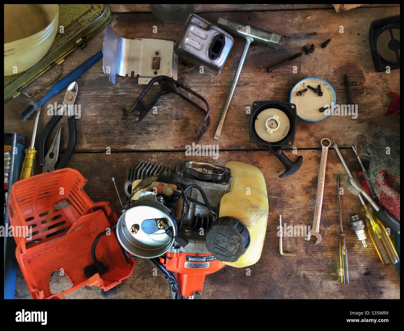 Rebuilding a brush-cutter two-stroke engine, Catalonia, Spain. - Smartphone Captured Stock Image
