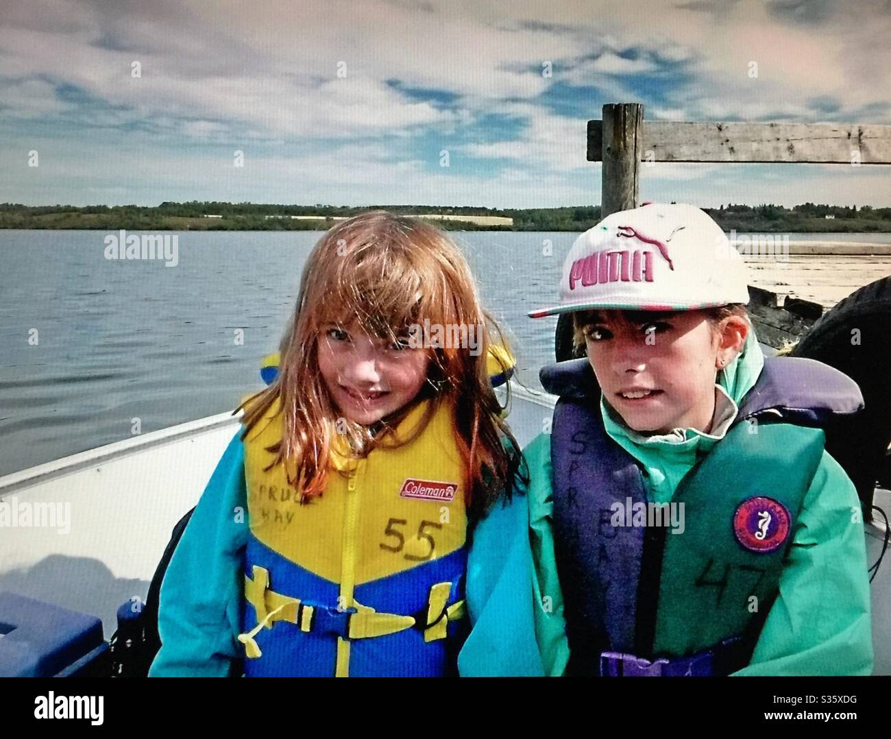 Family fun, Fishing on Pine Lake , Alberta, Canada, two sisters - Smartphone Captured Stock Image