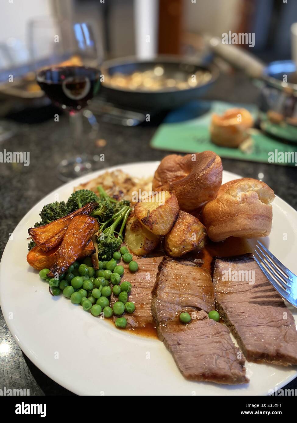 Beef roast dinner with a glass of red wine Stock Photo Alamy