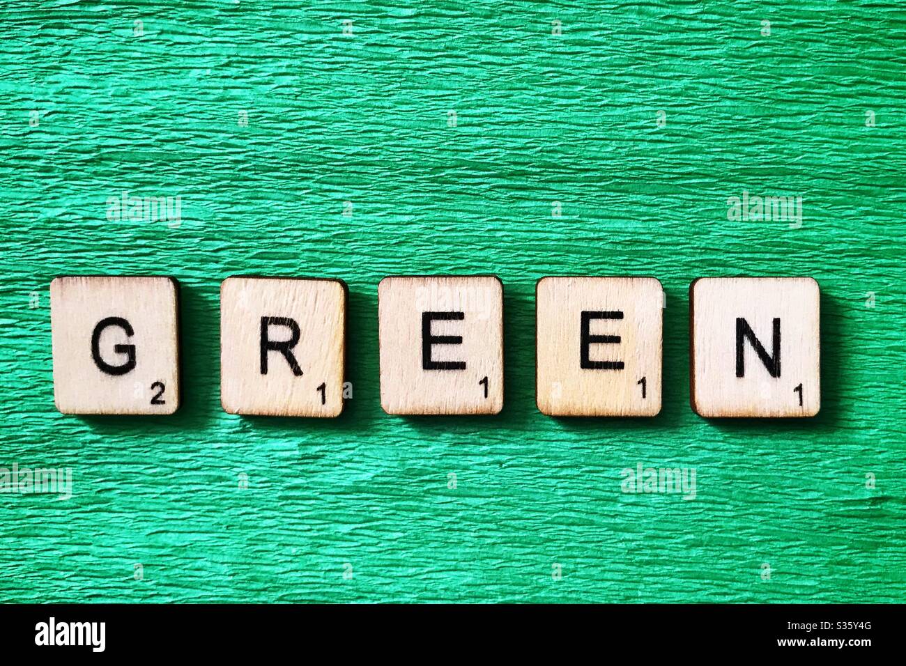 Wooden tiles spell out Green. - Smartphone Captured Stock Image