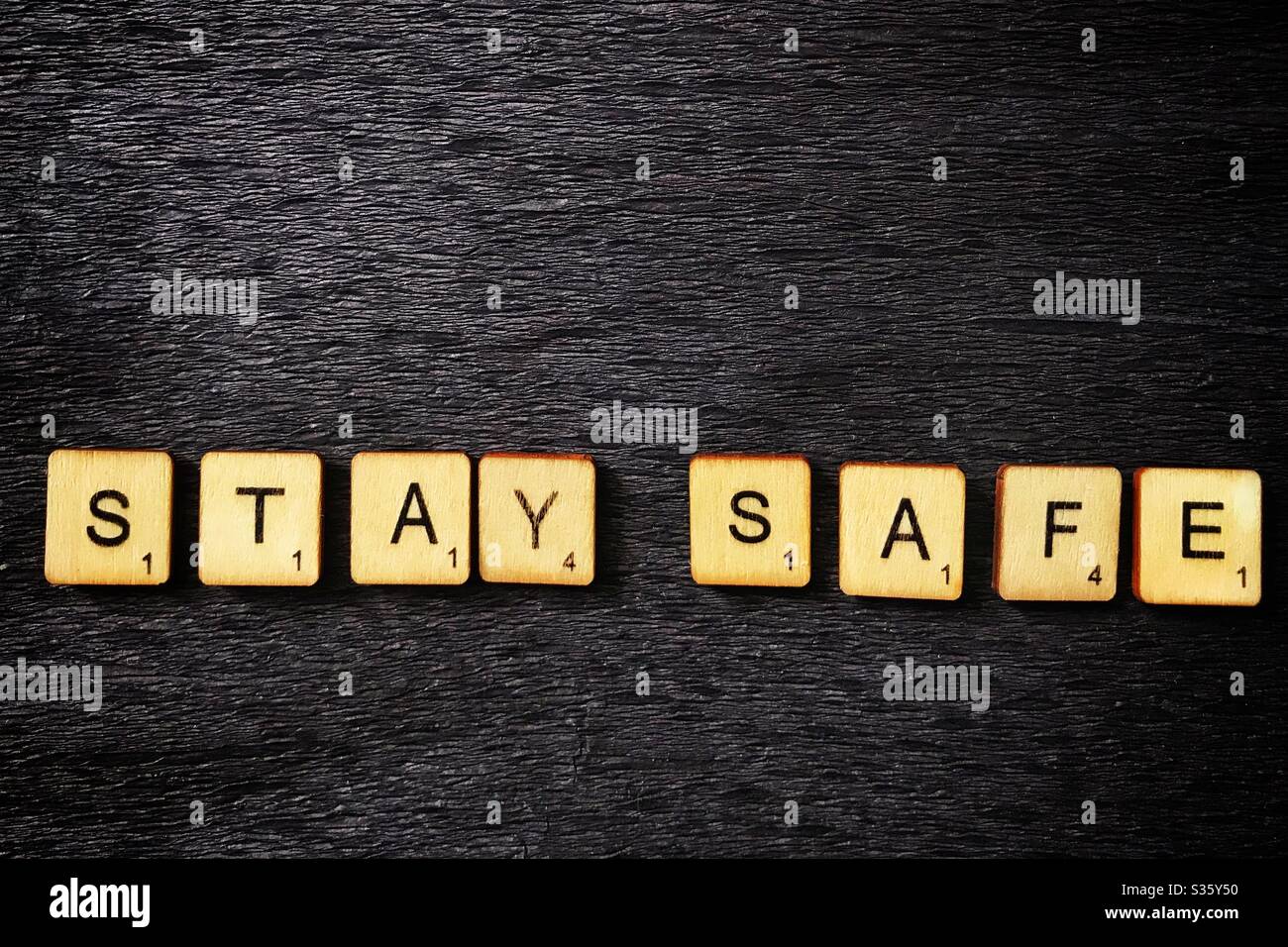 Wooden tiles spell out Stay Safe. Stock Photo