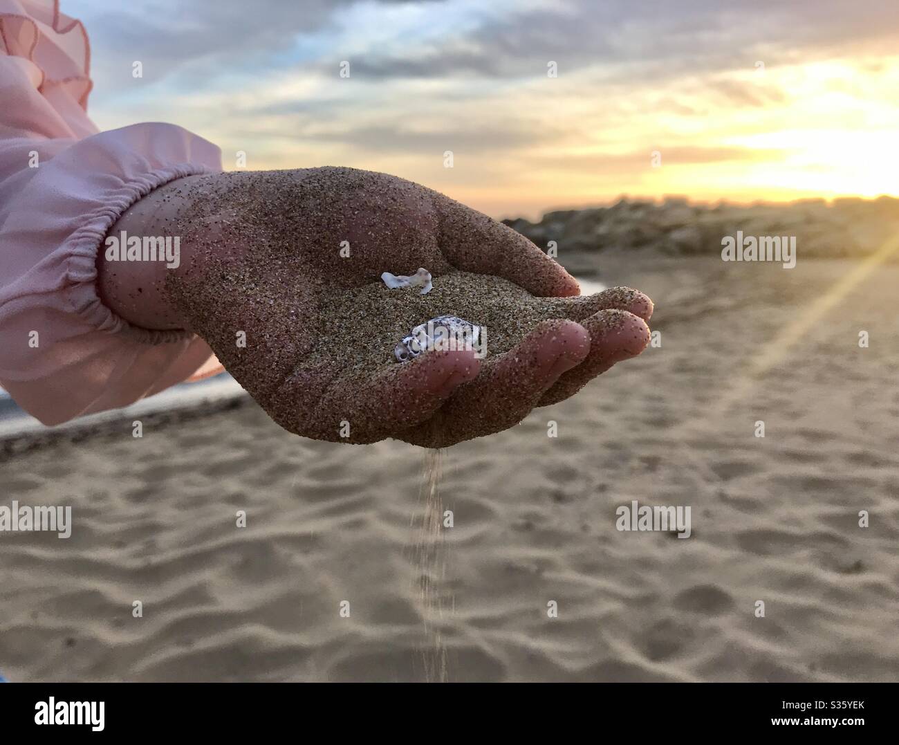 Sand falling down from the child hand Stock Photo