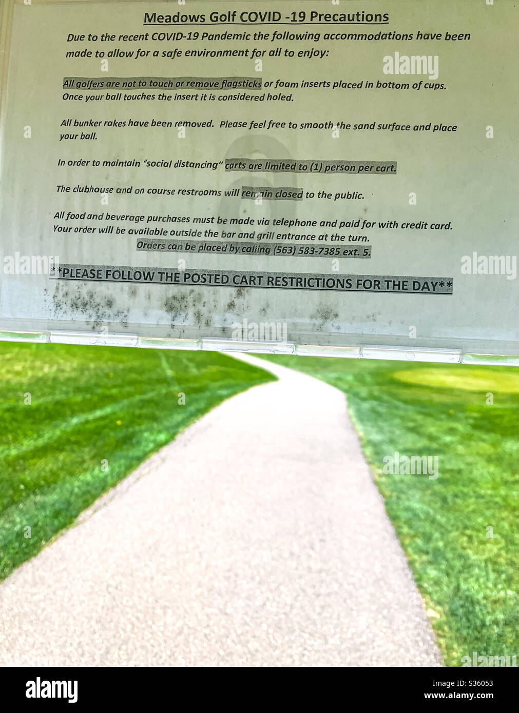 DUBUQUE, IOWA, May 3, 2020–Closeup photo of signage posted in golf cart regarding protocol in place during Covid-19 pandemic at a local golf course on beautiful spring day. Stock Photo