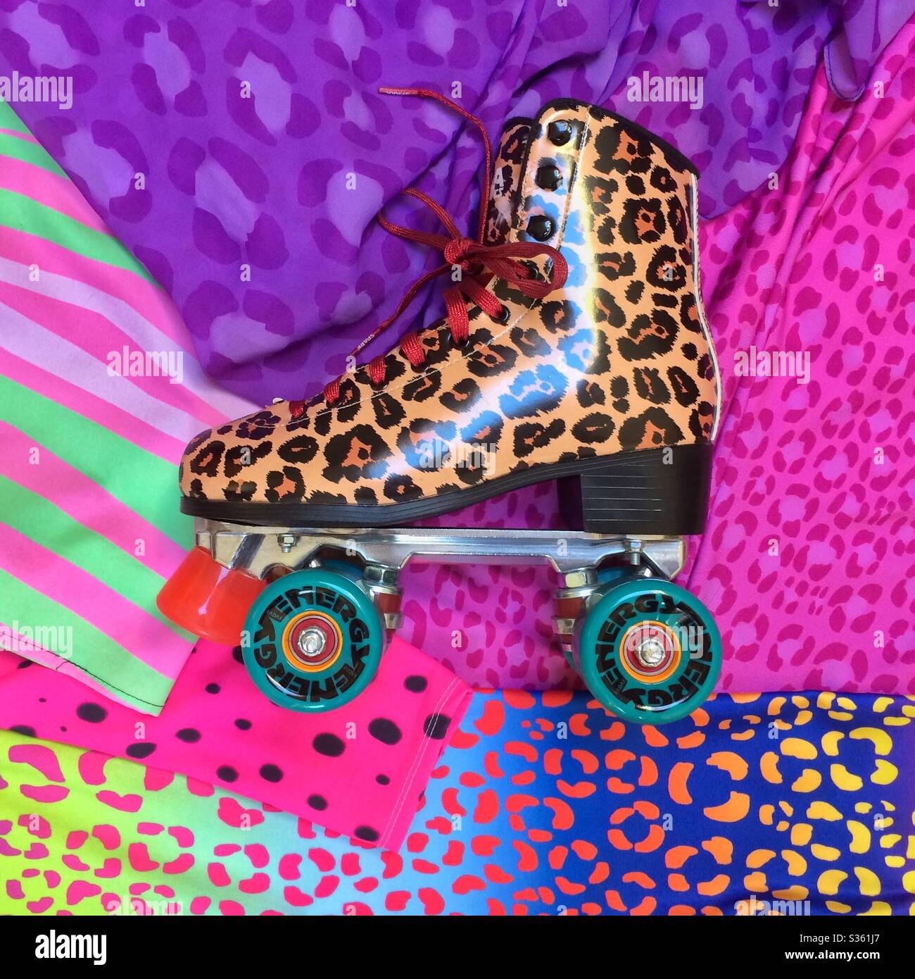 Leopard print roller skate on a background of vibrant animal print