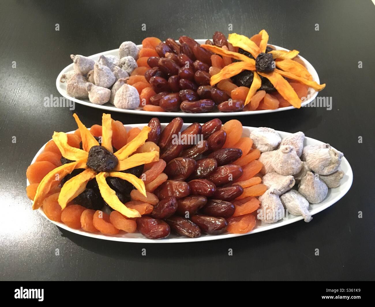 Dried fruit platters with floral design on white ceramic side dishes