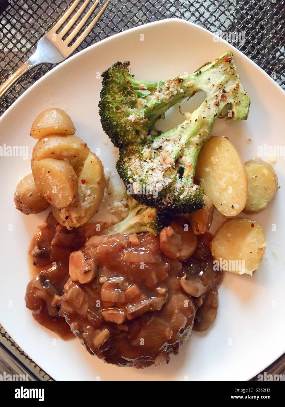 Americanized version of the famous Hawaiian loco Mocho dish accompanied by fingerling potatoes and braised broccoli, USA - Smartphone Captured Stock Image