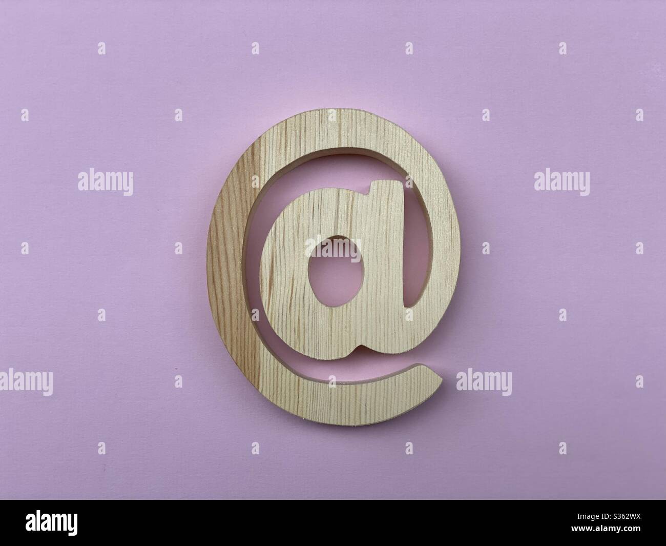Wooden At Symbol Email on pink color - Smartphone Captured Stock Image