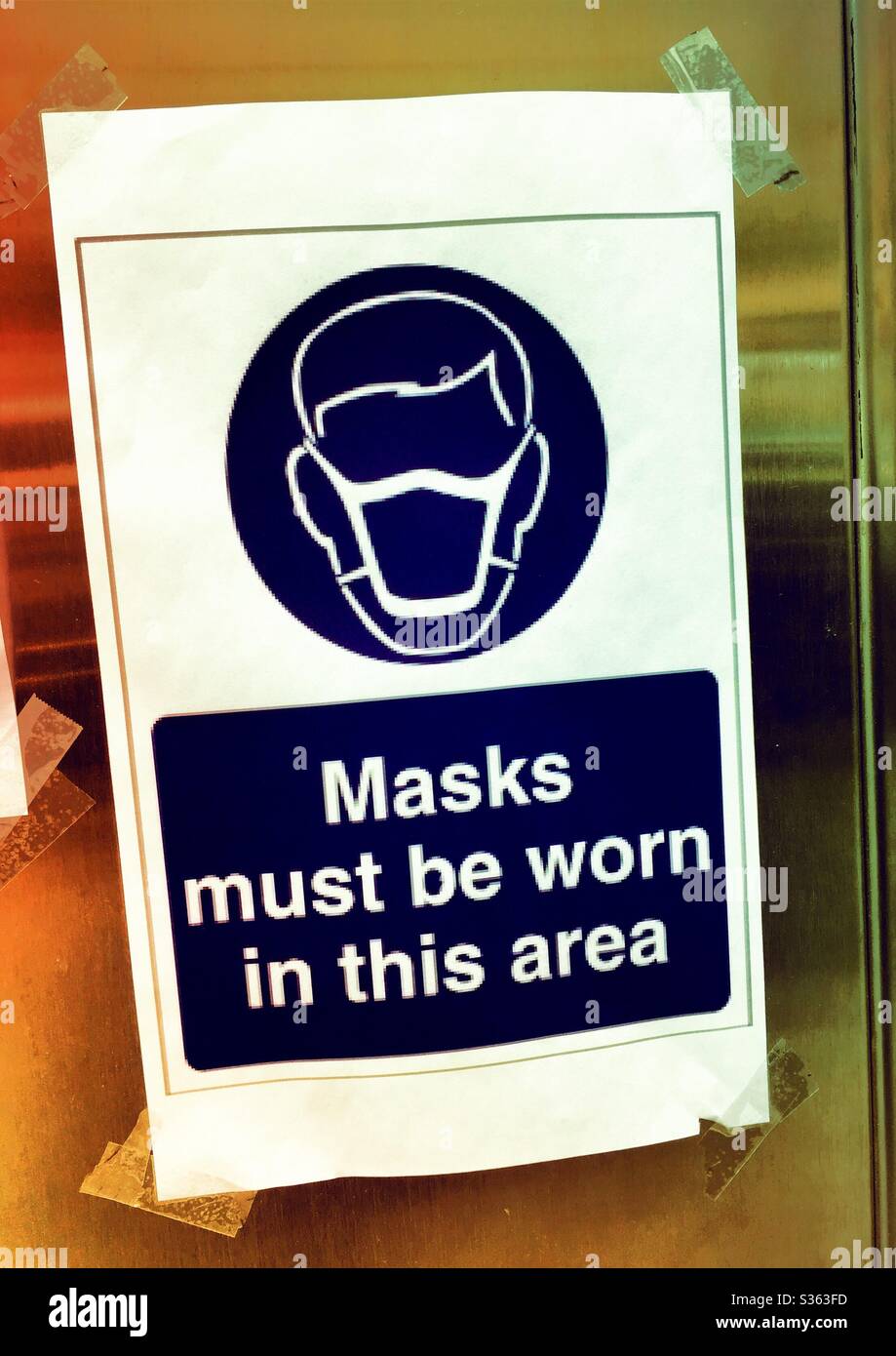 Sign advising the public that mask must be worn in this area during the COVID-19 pandemic, 2020, NYC, USA - Smartphone Captured Stock Image