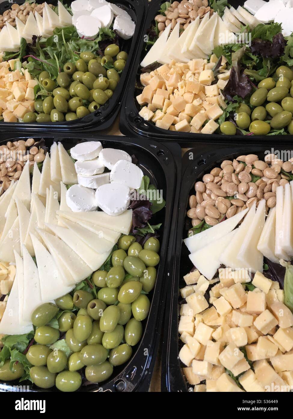 Cheese tray featuring marcona almonds and olives Stock Photo Alamy