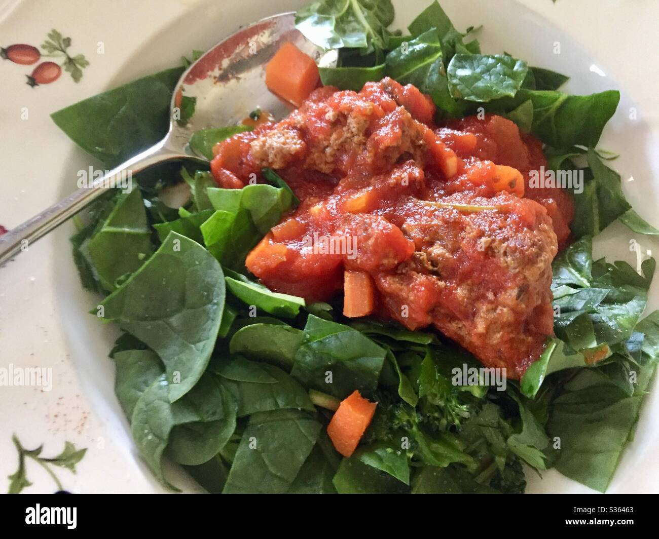 Spinach salad primavera, spinach salad with tomato sauce and vegetables, spinach salad with meatballs and tomato sauce - Smartphone Captured Stock Image