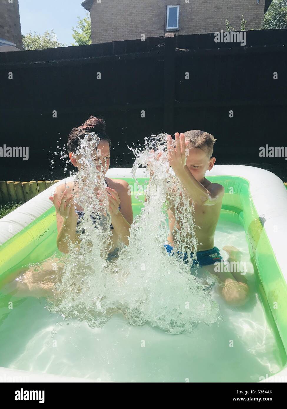 Water fun in paddling pool Stock Photo Alamy