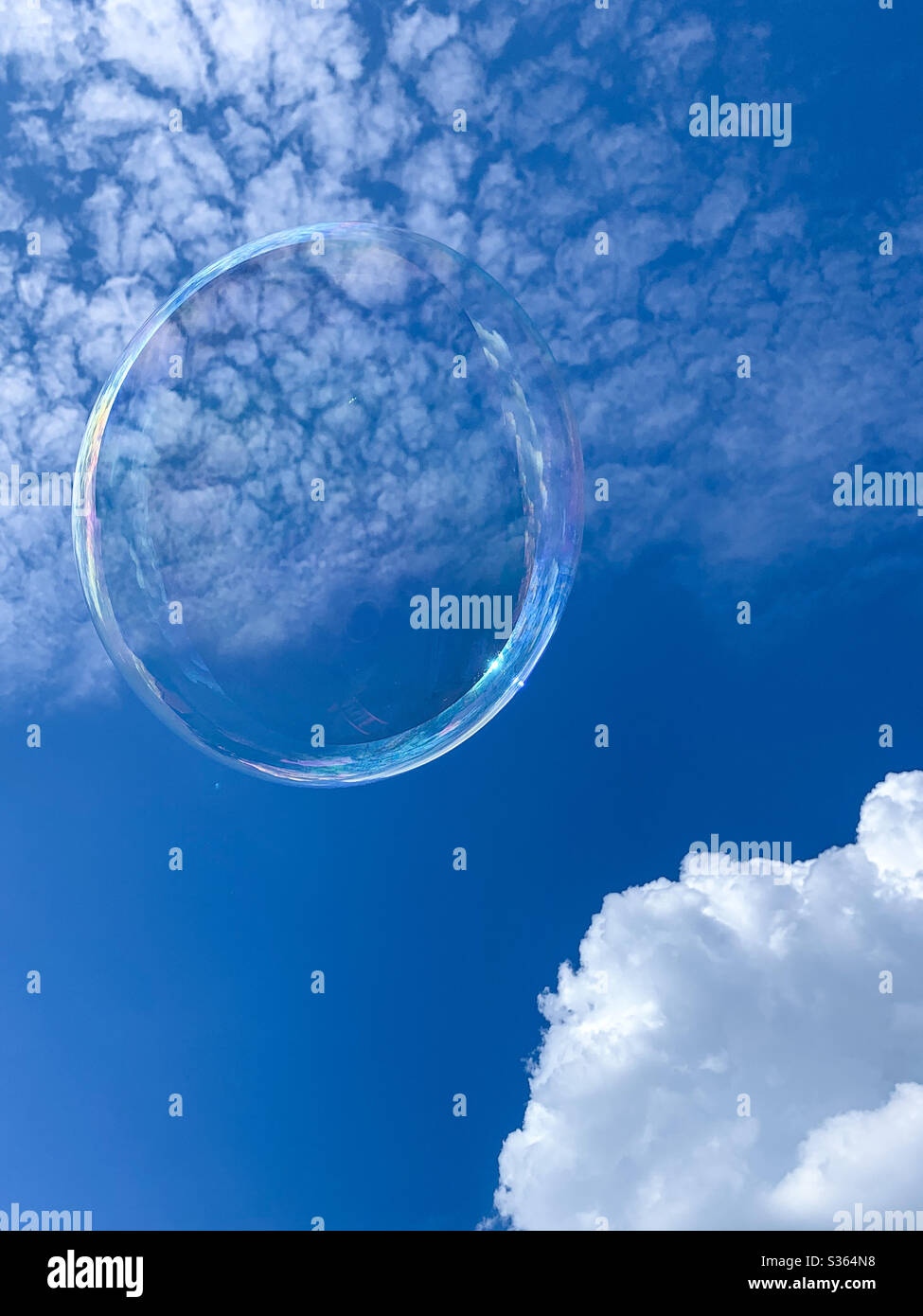 Bubble floating in a blue sky.  Open sky.  Thinking Stock Photo