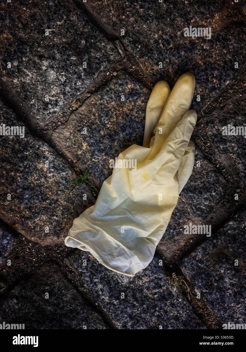 Abandoned protective gloves on the floor Stock Photo