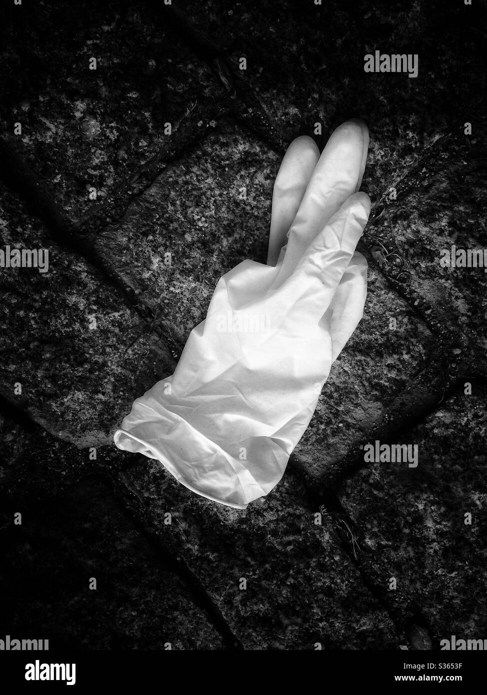 Abandoned protective glove on the floor Stock Photo