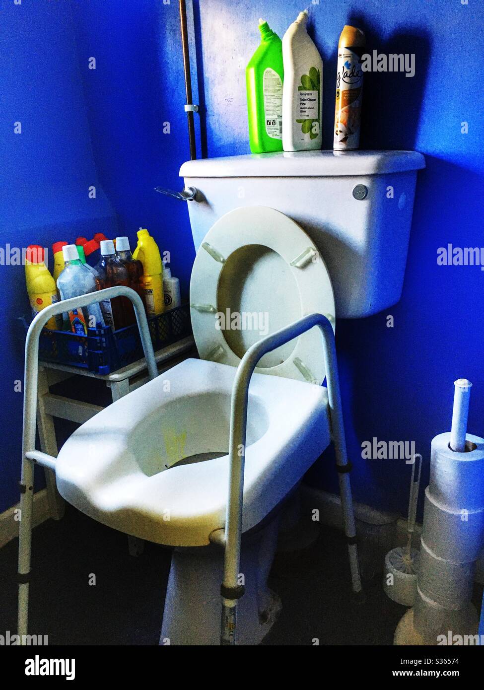 Toilet with raised seat and handles for an elderly person - Smartphone Captured Stock Image