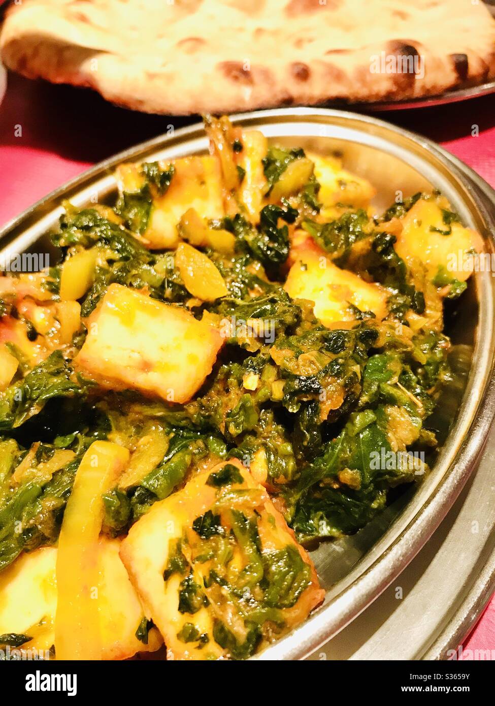 Closeup view of Indian curry with chicken, spinach and paneer cheese