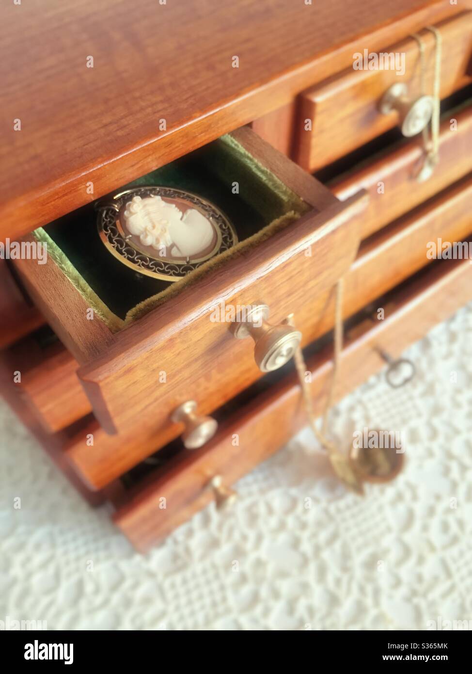 Vintage handcrafted wooden jewelry box with its drawers open Stock