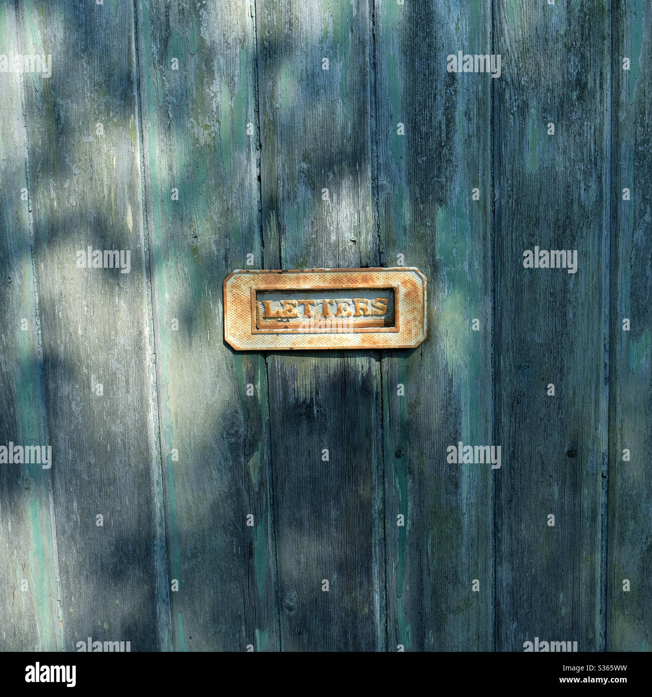 Letter box on an old wooden painted door  - letters - letterbox Stock Photo