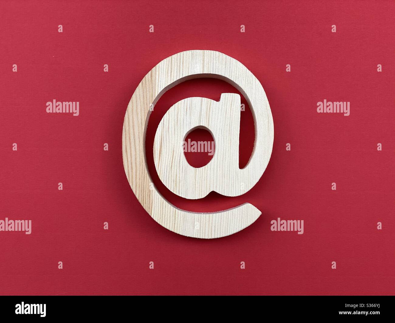 Wooden At Symbol Email on red color - Smartphone Captured Stock Image