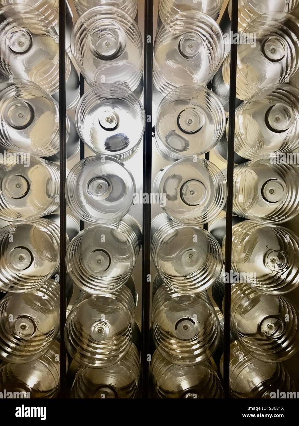 Plastic water bottles in a rack in New York hotel for filling from filtered water fountain. - Smartphone Captured Stock Image