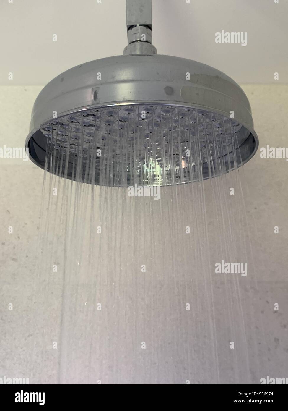 Shower head with water coming out of the nozzles - Smartphone Captured Stock Image