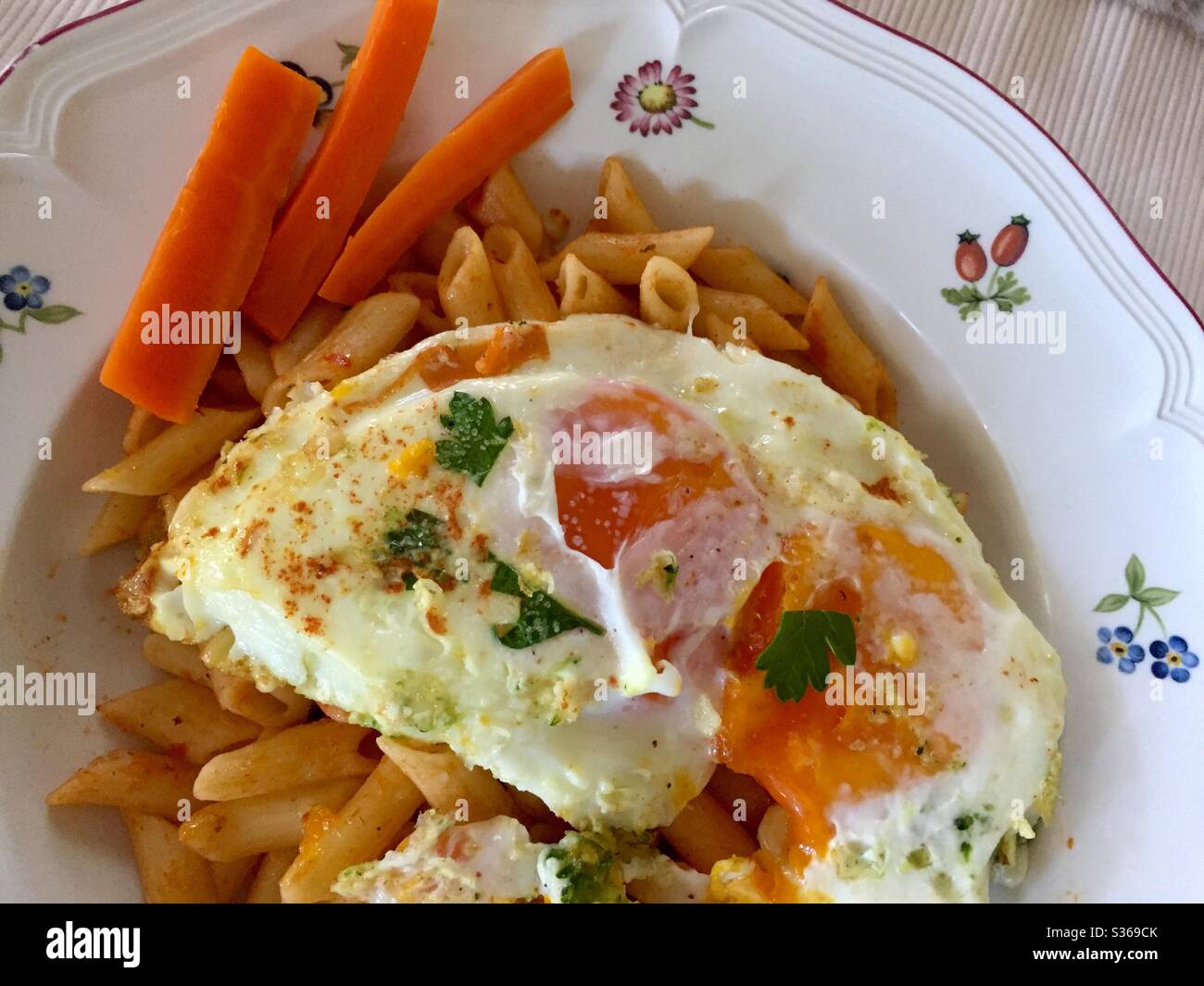 Eggs over easy on coconut tortilla with pasta - Smartphone Captured Stock Image