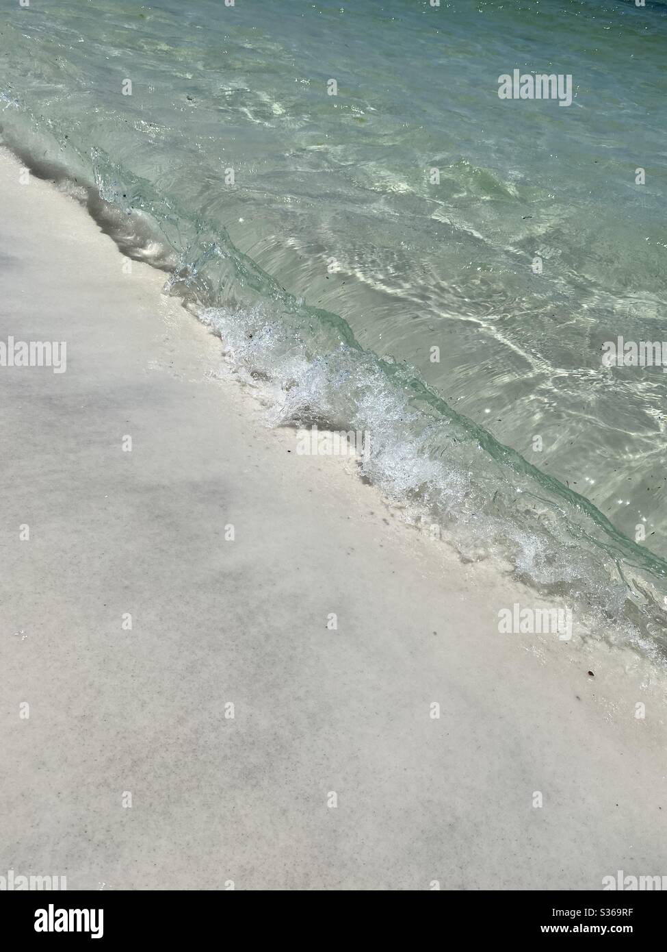 Waves hitting the sand on the beach - Smartphone Captured Stock Image