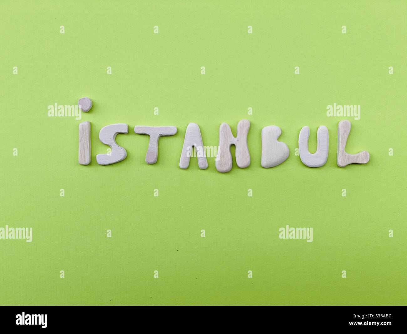 Istanbul, souvenir composed with handmade wooden letters on green color - Smartphone Captured Stock Image