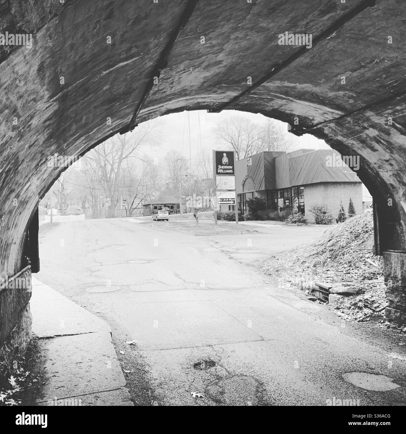 Black and white image of a road beneath a bridge in Greenfield, Massachusetts, United States - Smartphone Captured Stock Image