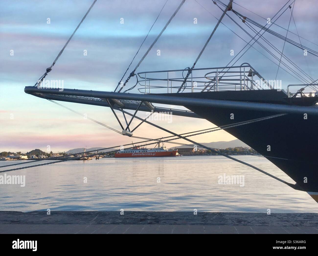 A Zanteferry berthed in Zante, Zakynthos, Greece, viewed through the bow of a sail ship. - Smartphone Captured Stock Image