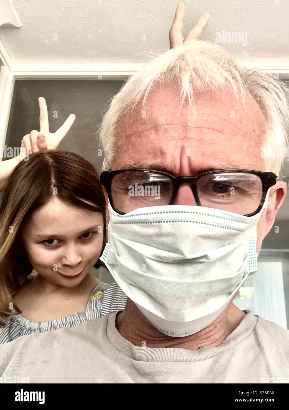 Dad and daughter. Daughter have fun - Smartphone Captured Stock Image