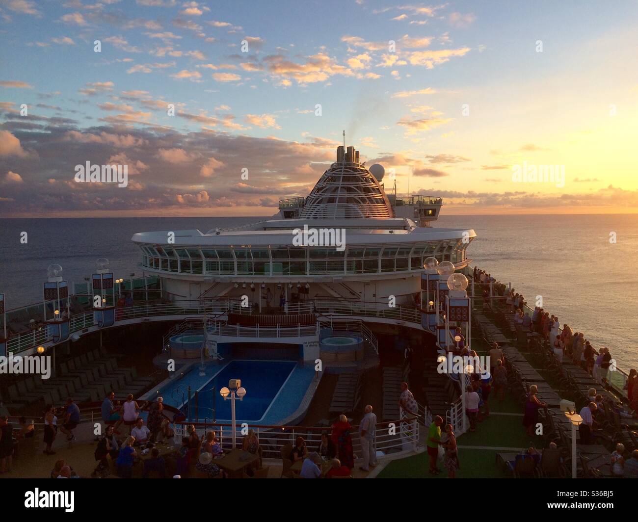 Cruise ship sets sail at sunset Stock Photo