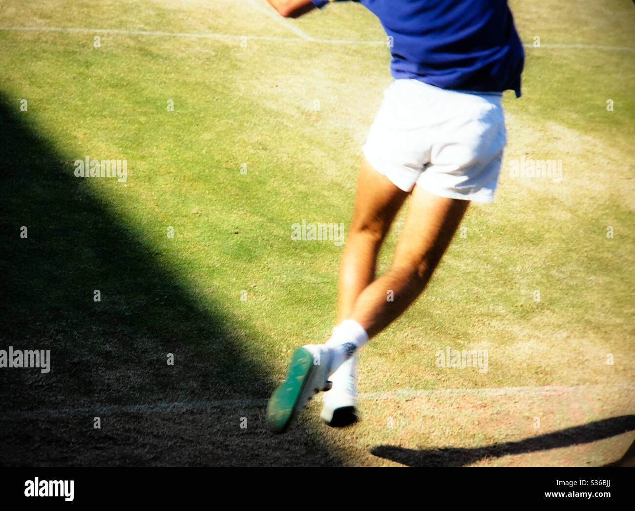 Wimbledon tennis championships player leaping in the air off the grass dreamy mood Stock Photo