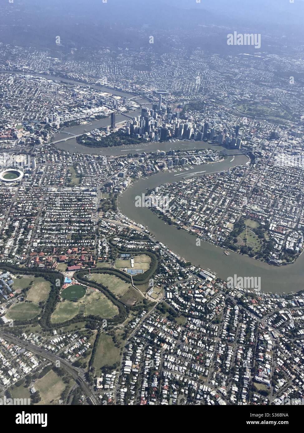 Aerial view of Brisbane City and river with Surrounding suburbs. Stock Photo