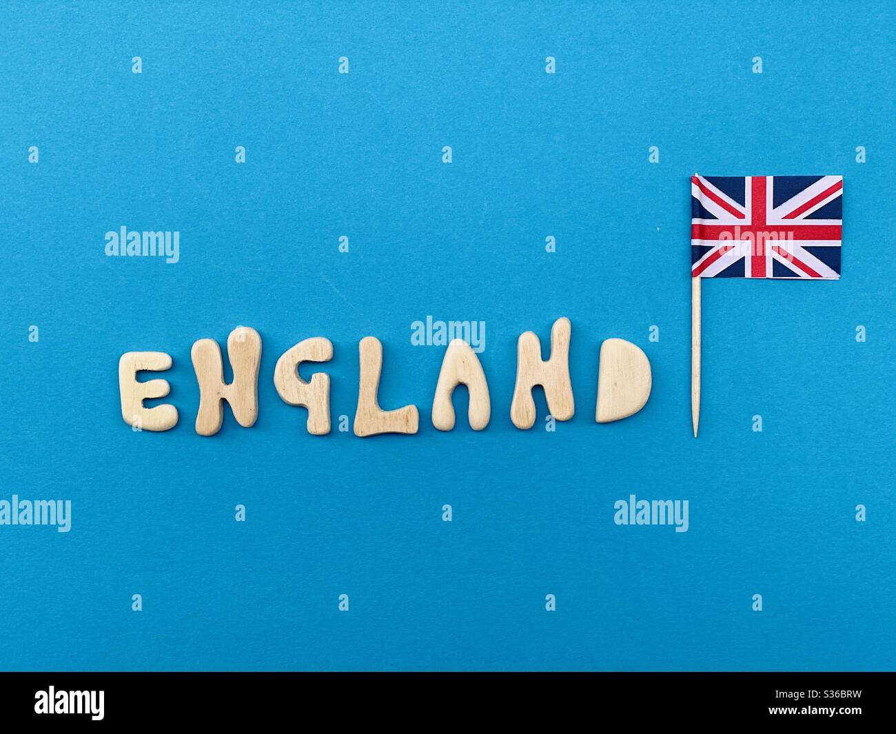 England, souvenir composed with handmade wooden letters over blue color - Smartphone Captured Stock Image