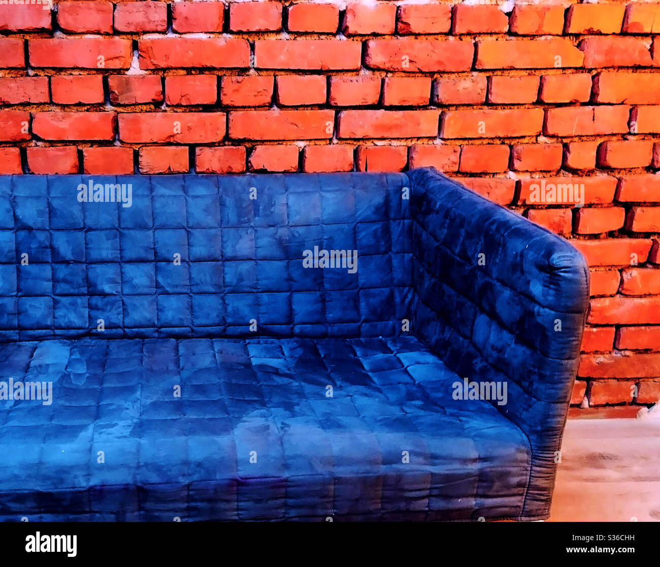 Blue sofa brick wall industrial style design Stock Photo Alamy