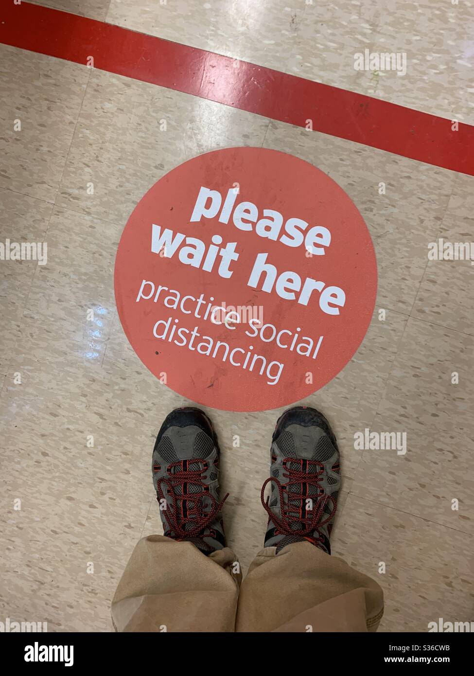 Please wait here in line to buy food , social distancing Stock Photo